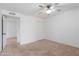 A bedroom with a fan and a window, adjacent to another room at 17808 N 45Th Ave, Glendale, AZ 85308