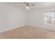 Bedroom featuring neutral carpet, bright window, and ceiling fan at 17808 N 45Th Ave, Glendale, AZ 85308