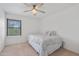 Bedroom with a window with blinds, a ceiling fan, and a bed with decorative pillows at 17808 N 45Th Ave, Glendale, AZ 85308