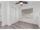 Bedroom featuring a ceiling fan, closet with sliding doors, and laminate flooring at 17808 N 45Th Ave, Glendale, AZ 85308