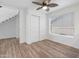 Bedroom featuring wood-look floors, closet, and a window with blinds at 17808 N 45Th Ave, Glendale, AZ 85308