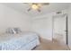 Bedroom with ceiling fan and a bed with a blue patterned comforter and decorative pillow at 17808 N 45Th Ave, Glendale, AZ 85308