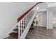 Inviting entryway featuring a staircase with wooden handrail, and light laminate flooring at 17808 N 45Th Ave, Glendale, AZ 85308