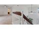 Bright hallway featuring neutral carpet, white walls, and a staircase leading to the lower level at 17808 N 45Th Ave, Glendale, AZ 85308