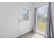 Bright hallway with a window and a door leading to the backyard at 17808 N 45Th Ave, Glendale, AZ 85308