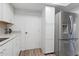 Bright kitchen featuring white cabinets, stainless steel refrigerator, and wood-look floors at 17808 N 45Th Ave, Glendale, AZ 85308