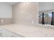 Bright kitchen counter boasts stylish tile backsplash and marble-patterned countertop at 17808 N 45Th Ave, Glendale, AZ 85308