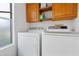 Laundry room with wooden cabinets and appliances at 17808 N 45Th Ave, Glendale, AZ 85308