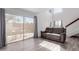 Spacious living room featuring a sliding door leading to a patio and laminate flooring at 17808 N 45Th Ave, Glendale, AZ 85308