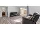 Open floor plan living room with laminate floors and patio access at 17808 N 45Th Ave, Glendale, AZ 85308