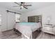Bright bedroom featuring modern furniture, ceiling fan, and ensuite bathroom access at 17808 N 45Th Ave, Glendale, AZ 85308