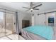 Large bedroom with sliding glass door and barn door access to ensuite at 17808 N 45Th Ave, Glendale, AZ 85308