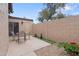 Cozy patio with a table and chairs, privacy wall, and beautiful floral accents at 17808 N 45Th Ave, Glendale, AZ 85308