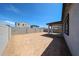 The backyard features a covered patio and a block wall, providing privacy at 18220 W Daley Ln, Surprise, AZ 85387
