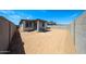 The backyard is enclosed by block walls and includes a covered patio at 18220 W Daley Ln, Surprise, AZ 85387
