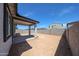 View of the backyard with block walls, a covered patio, and space for customization at 18220 W Daley Ln, Surprise, AZ 85387