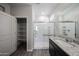 Bathroom features large glass-enclosed shower, with walk-in closet space and a single sink vanity at 18220 W Daley Ln, Surprise, AZ 85387