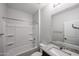 Bright bathroom features a shower-tub combination and granite vanity at 18220 W Daley Ln, Surprise, AZ 85387