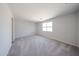 Bright bedroom with neutral carpet, natural light and space at 18220 W Daley Ln, Surprise, AZ 85387