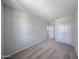 A minimalist bedroom with neutral carpet, closet doors, and a window that invites soft, natural light at 18220 W Daley Ln, Surprise, AZ 85387