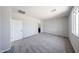 Spacious bedroom with large window, plush carpet, and access to an en-suite bathroom at 18220 W Daley Ln, Surprise, AZ 85387