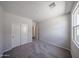 A spacious bedroom with neutral walls, carpet, a window, and a closet; ready to become a comfortable retreat at 18220 W Daley Ln, Surprise, AZ 85387