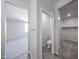 Hallway leading to bedroom with a half bathroom and walk-in closet at 18220 W Daley Ln, Surprise, AZ 85387