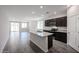 Open-concept kitchen boasts a granite island, stainless appliances, and sleek countertops at 18220 W Daley Ln, Surprise, AZ 85387