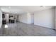 Expansive living room with contemporary flooring offers plenty of natural light at 18220 W Daley Ln, Surprise, AZ 85387
