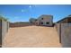 Large dirt backyard with block fence and a covered patio; a blank canvas for outdoor living at 18244 W Daley Ln, Surprise, AZ 85387