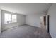 Bright bedroom features plush carpeting and a large window for natural light and neighborhood views at 18244 W Daley Ln, Surprise, AZ 85387