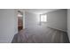 Bright bedroom with plush carpeting and a window, creating a cozy and inviting space at 18244 W Daley Ln, Surprise, AZ 85387