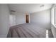 Light-filled bedroom with plush carpeting and views of the surrounding neighborhood at 18244 W Daley Ln, Surprise, AZ 85387