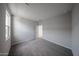 Bedroom with gray carpet and neutral walls, featuring a bright window and closet entrance at 18244 W Daley Ln, Surprise, AZ 85387