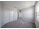 Bright bedroom with a closet featuring white sliding doors and a window that offers natural light at 18244 W Daley Ln, Surprise, AZ 85387