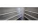Walk-in closet featuring white shelving, providing plenty of storage space at 18244 W Daley Ln, Surprise, AZ 85387