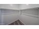 Walk-in closet features white walls, carpet, and closet rod for ample storage at 18244 W Daley Ln, Surprise, AZ 85387