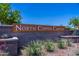 Elegant stone entrance sign reading North Copper Canyon, surrounded by desert landscaping at 18244 W Daley Ln, Surprise, AZ 85387