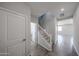 Bright entryway with tile flooring, a staircase, and doors leading to other rooms at 18244 W Daley Ln, Surprise, AZ 85387
