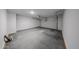 View of the spacious three car garage featuring concrete flooring and ample ceiling height at 18244 W Daley Ln, Surprise, AZ 85387