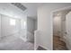 Upstairs hallway with plush carpeting and access to the bathroom at 18244 W Daley Ln, Surprise, AZ 85387