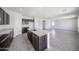 Stylish kitchen with a center island, granite countertops, and dark wood cabinetry at 18244 W Daley Ln, Surprise, AZ 85387