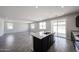 Open kitchen concept featuring a center island with a sink and connection to the living area at 18244 W Daley Ln, Surprise, AZ 85387