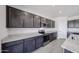 Modern kitchen showcasing stainless steel appliances, granite countertops, and dark wood cabinets at 18244 W Daley Ln, Surprise, AZ 85387