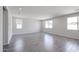 Large living room with tile floors and multiple windows providing lots of natural light at 18244 W Daley Ln, Surprise, AZ 85387