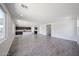 Open-concept living space with tile flooring, bright windows, and a view into the kitchen area at 18244 W Daley Ln, Surprise, AZ 85387