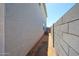 Exterior shot of the side yard, featuring stucco wall and block fence, between two houses at 18244 W Daley Ln, Surprise, AZ 85387