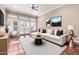 Bright living room with a ceiling fan, large windows, and a comfortable, stylish sofa at 333 N Pennington Dr # 55, Chandler, AZ 85224