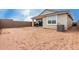 View of the home's backyard, tan stucco, a covered patio, and air conditioning unit at 10347 S Saguaro Dr, Apache Junction, AZ 85120