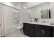 Bright bathroom with a double vanity, shower and neutral patterned curtain at 10347 S Saguaro Dr, Apache Junction, AZ 85120